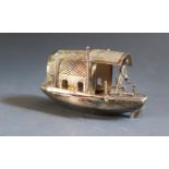 A Small Hong Kong Silver Boat with figure tilling the boat at the stern, 68mm long, Wang Hing & Co.,