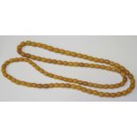 A 50" Faux Amber Bead Necklace, 111.9g