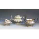 A George V Silver Three Part Tea Set with gadrooned decoration, Birmingham 1911 teapot and 1912