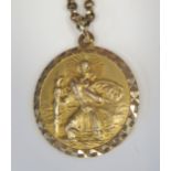 A 9ct Gold St. Christopher Pendant (24mm diam.) on a 17" 9ct gold chain, 11.8g