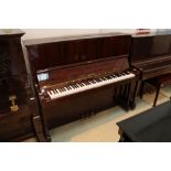 Petrof (c1996) An upright piano in a traditional bright mahogany case.