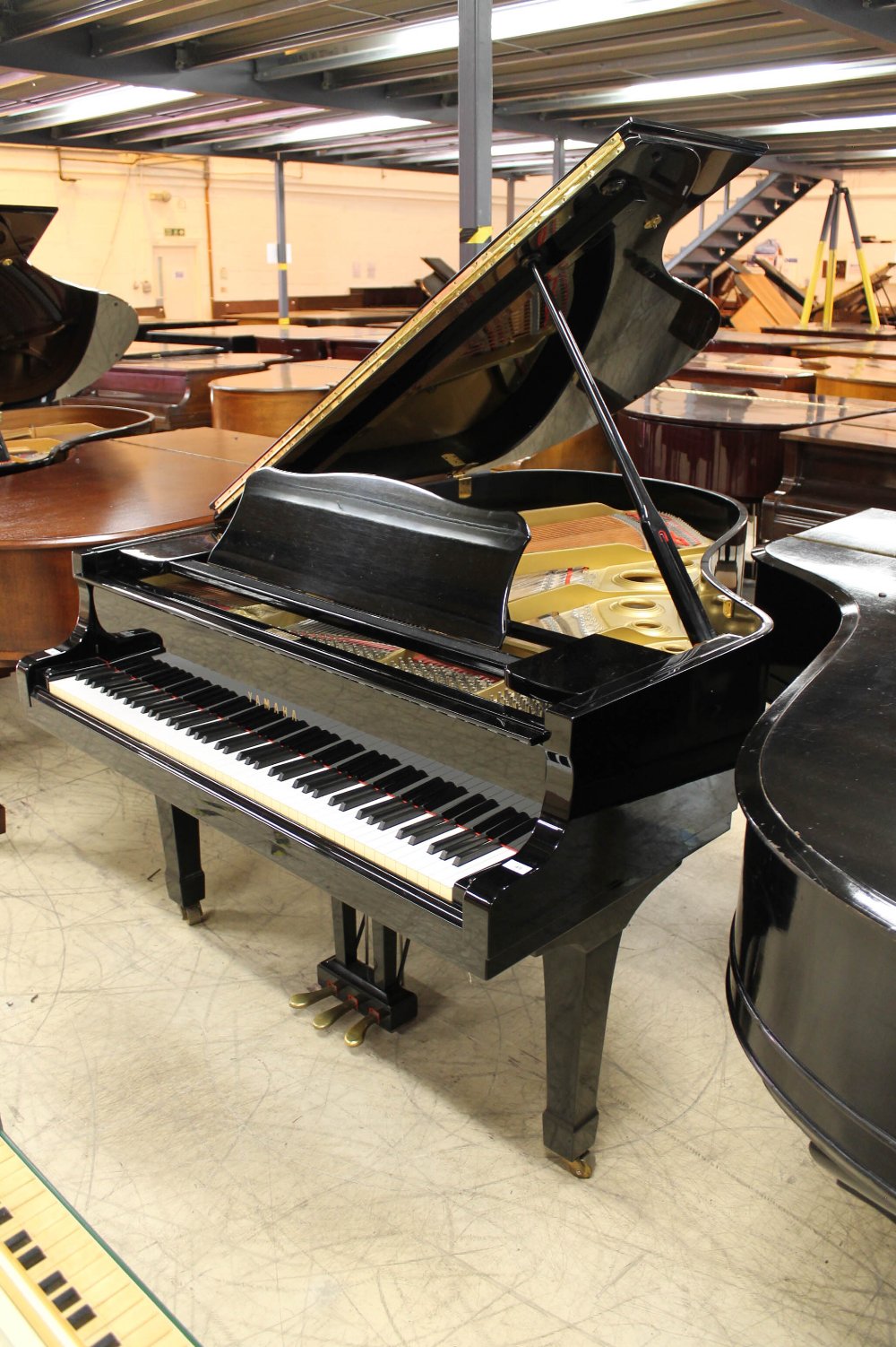 Yamaha (c1984) A 6ft 1in Model C3 grand piano in a bright ebonised case on square tapered legs.