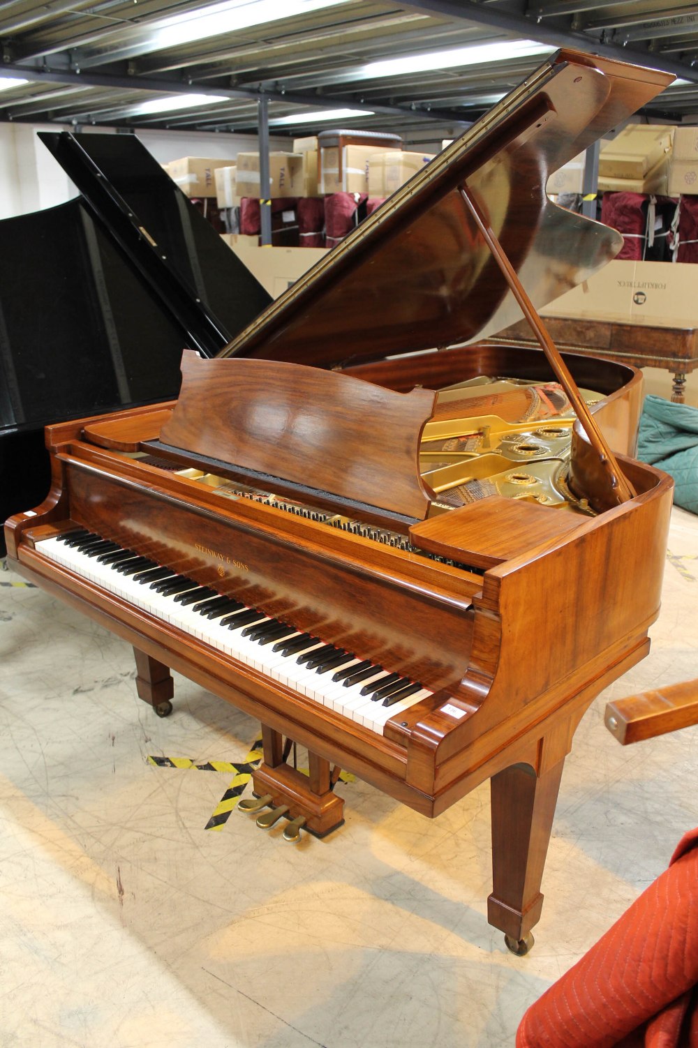 Steinway (c1928) A 7ft 5in grand piano in a French polished rosewood case on square tapered legs.