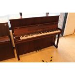 Klug & Sperl A modern upright piano in a traditional satin mahogany case.