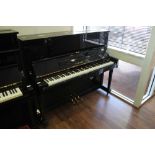 Yamaha (c1977) A Model U1 upright piano in a bright ebonised case; together with a stool.