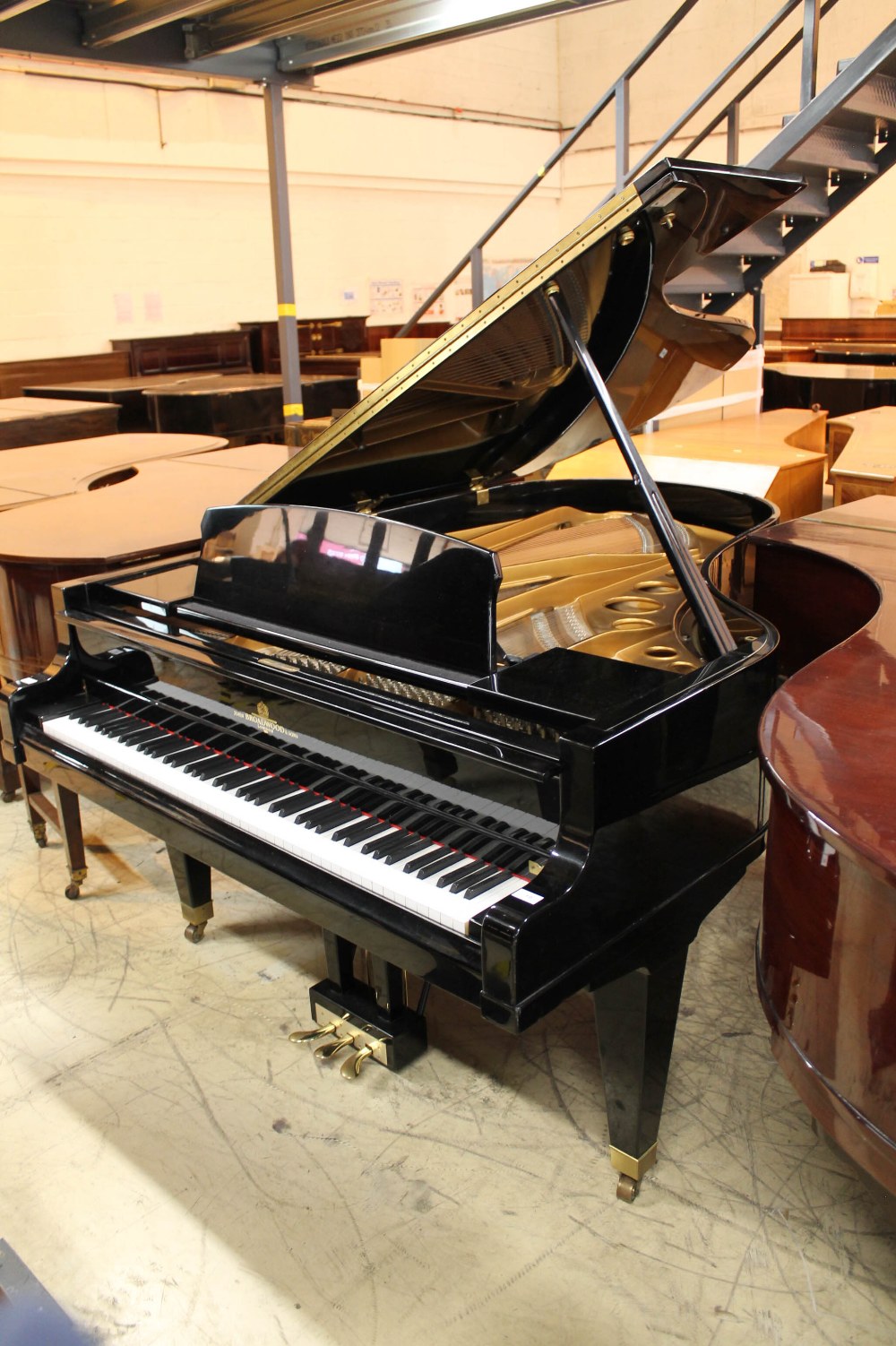 Broadwood A recent 6ft 3in grand piano in a bright ebonised case on square tapered legs.