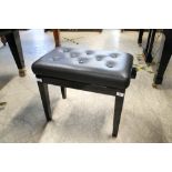 Piano Stool An ebonised concert adjustable stool with button upholstered leather top.
