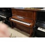 Broadwood (c1910) An upright piano in a mahogany case.