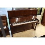 Petrof (c1982) An upright piano in a traditional bright mahogany case; together with a stool.