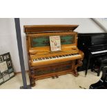 Brinsmead (c1855) An upright piano in a birch case with carved keyboard supports and an ornate