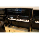 Yamaha (c1986) A Model U30 upright piano in a bright ebonised case.