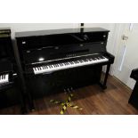 Yamaha (c2010) A Model P116 upright piano in a bright ebonised case.