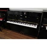 Kawai (c2013) A Model K-15E upright piano in a modern style bright ebonised case;