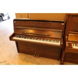 Knight (c1997) A Model K10 upright piano in a satin walnut case.