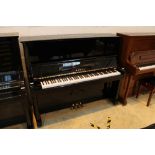 Kawai (c1977) An upright piano in a bright ebonised case. AMENDMENT Is a Model BL-12.