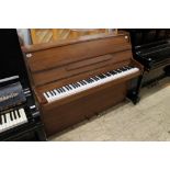 Kemble (c1989) An upright piano in a modern style mahogany case.