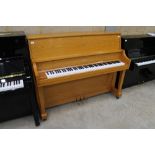 Boston (c2008) A Model UP-1185 upright piano in a satin honey oak case. There is VAT on this Lot.