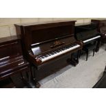 Steinway (c1914) An upright piano in a traditional rosewood case; together with a stool.