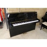 Yamaha (c1989) A Model C108 upright piano in a bright ebonised case.