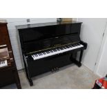 Yamaha (c1976) A Model U1H upright piano in a bright ebonised case.