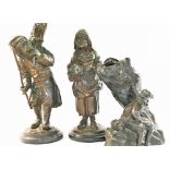 A pair of bronze figures of elderly peasants carrying bundles of sticks, on circular marble base,