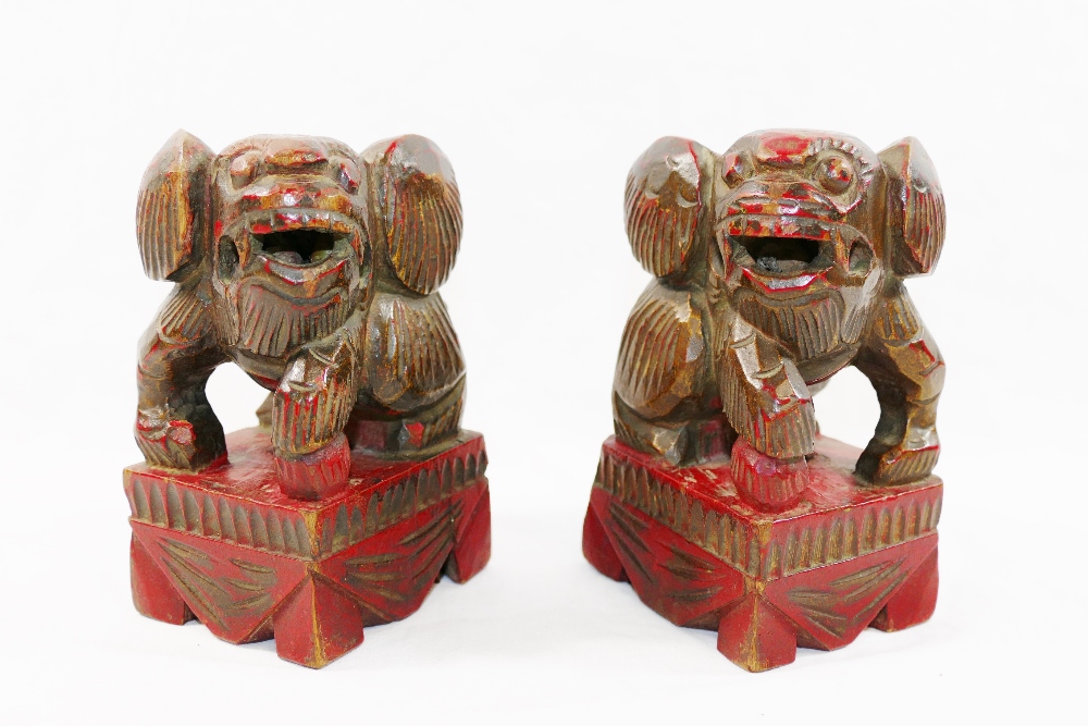 A small pair of Chinese carved wooden temple dogs of foo, painted in red and gilt, on square bases, - Image 2 of 6