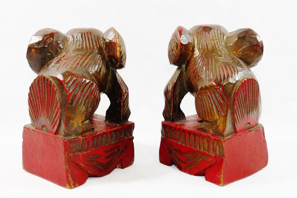 A small pair of Chinese carved wooden temple dogs of foo, painted in red and gilt, on square bases, - Image 6 of 6