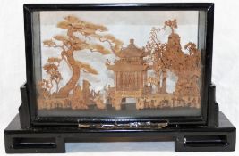 A 20th century Chinese carved cork landscape diorama, depicting trees, a pagoda and cranes,