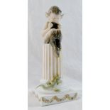 A Royal Copenhagen porcelain figure of a fawn seated on a pillar playing the pipes,