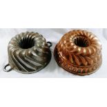 A large Victorian copper jelly mould, with hollow centre and layered spiral and fluted design,