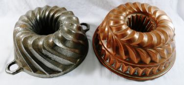 A large Victorian copper jelly mould, with hollow centre and layered spiral and fluted design,