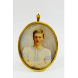A late Victorian oval portrait miniature on ivory of a young man in a Cambridge University athletic