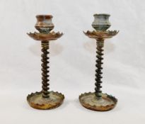 A pair of copper and brass trench art candlesticks with twisted wire stems,