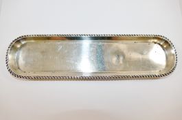 An early 20th century silver pen tray, Birmingham 1912, with gadrooned rim, 24.8cm x 6.5cm, 3.