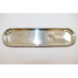 An early 20th century silver pen tray, Birmingham 1912, with gadrooned rim, 24.8cm x 6.5cm, 3.