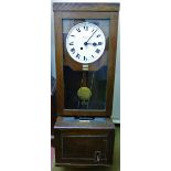 A Simplex oak cased clocking in clock, numbered 75915,