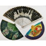 A 1920's paper fan depicting the New York skyline, with silver painted sticks and guards,