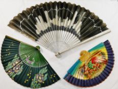 A 1920's paper fan depicting the New York skyline, with silver painted sticks and guards,