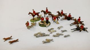 A collection of hand painted cast lead hunting figures, including two foxes, hounds, puppies,