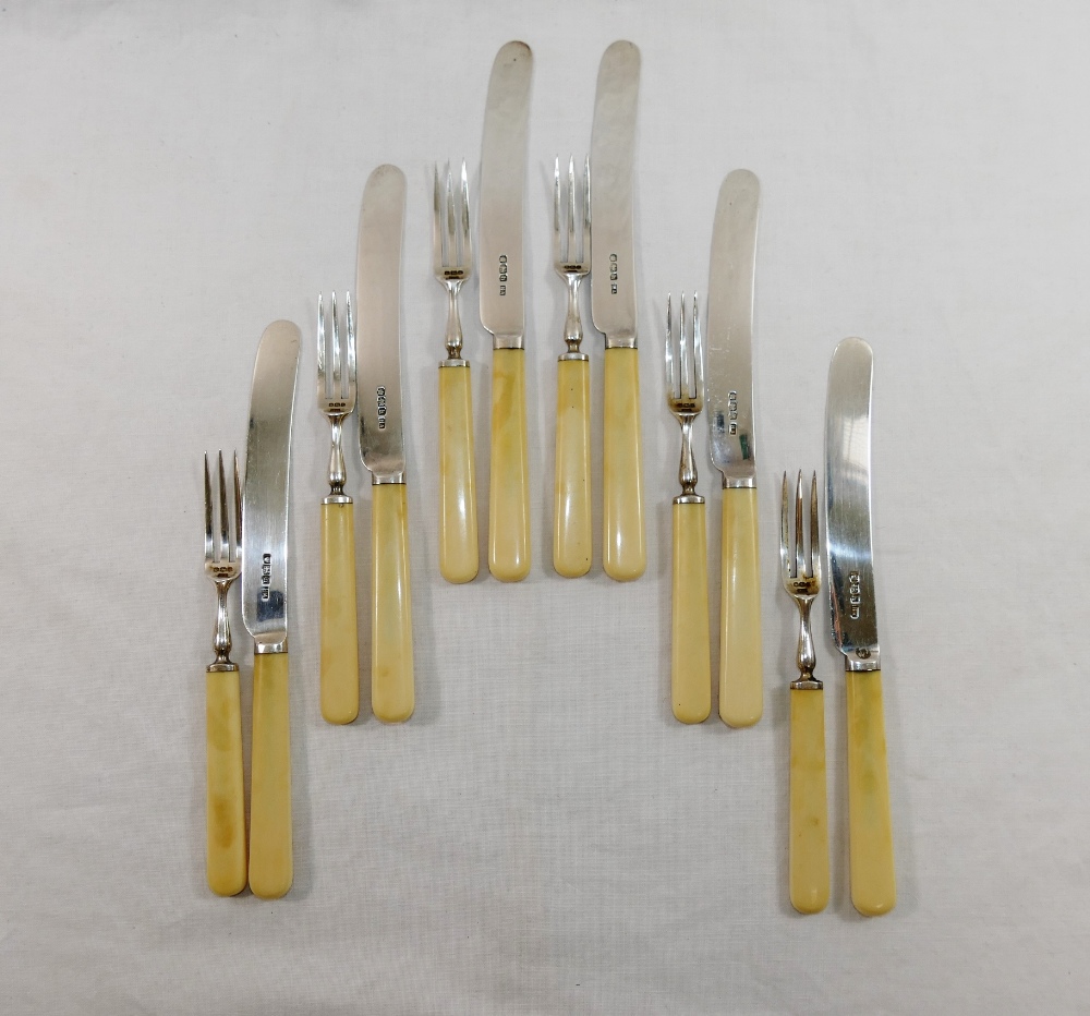 A set of George V ivory handled silver tea knives and cake forks for six place settings,