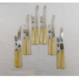 A set of George V ivory handled silver tea knives and cake forks for six place settings,