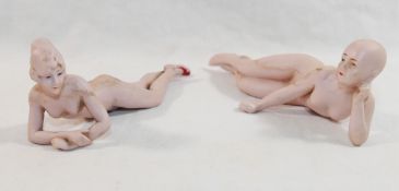 A German porcelain bisque figure of a nude woman lying on her front, wearing red painted shoes,