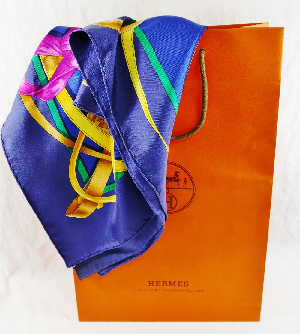 A Hermes blue ground 'Grand Manège' silk scarf, by Henri d'Origny, 89cm x 89cm,