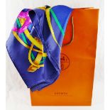 A Hermes blue ground 'Grand Manège' silk scarf, by Henri d'Origny, 89cm x 89cm,