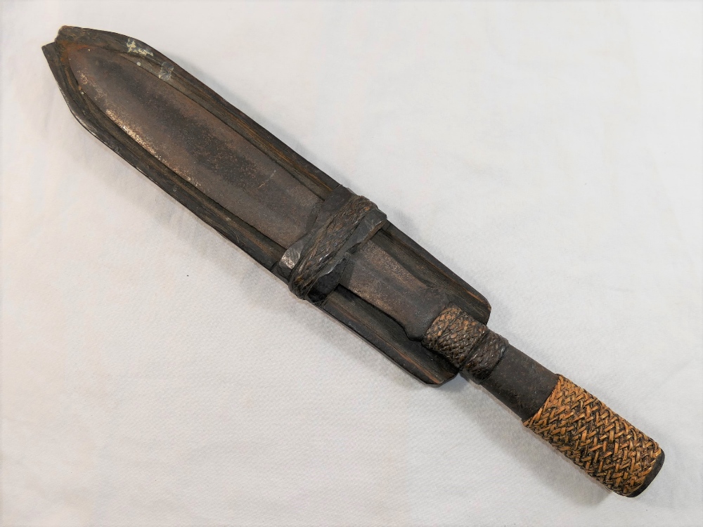 An antique steel tribal dagger/knife, the hollow handle with braided reed grip and ornamentation,