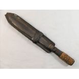 An antique steel tribal dagger/knife, the hollow handle with braided reed grip and ornamentation,