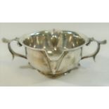 An Arts and Crafts silver two handled and double spouted porringer style bowl,