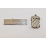 A small silver cased retractable comb with import marks for London 1926,