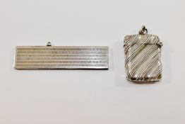 A small silver cased retractable comb with import marks for London 1926,