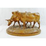 A Swiss Brienz carving of two horned cows, one with a bell,